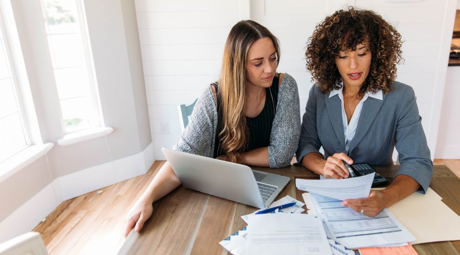 Financial advisor meeting with a client discussing financial planning and well-being